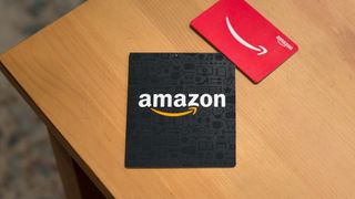 Amazon gift cards shown on a wooden table