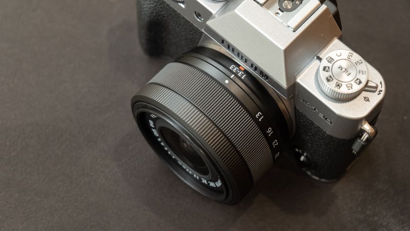 Close-up of the 13-33mm lens on a Fujifilm X-T30 III camera on a dark surface