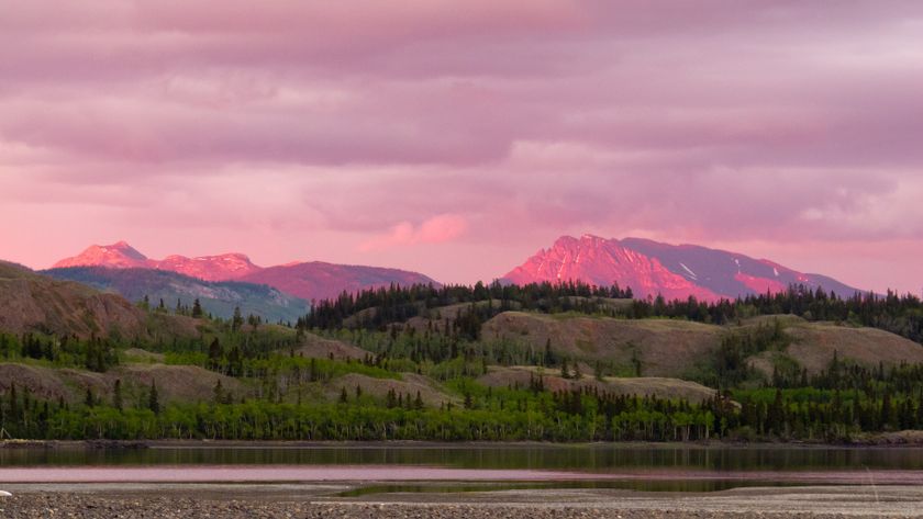 Distant mountains glowing in sunset light at Lake Laberge, Yukon Territory, Canada.