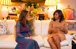 Catherine, Duchess of Cambridge speaks with First Lady of the United States Michelle Obama in the Drawing Room of Apartment 1A Kensington Palace as they attend a dinner on April 22, 2016 in London, England.