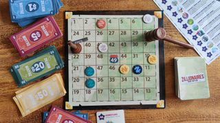 Zillionaires: Road Trip USA board, tokens, cards, and money on a wooden table