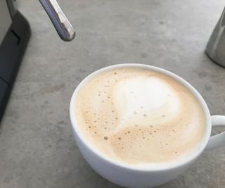 De'Longhi Dedica Arte making a cappuccino