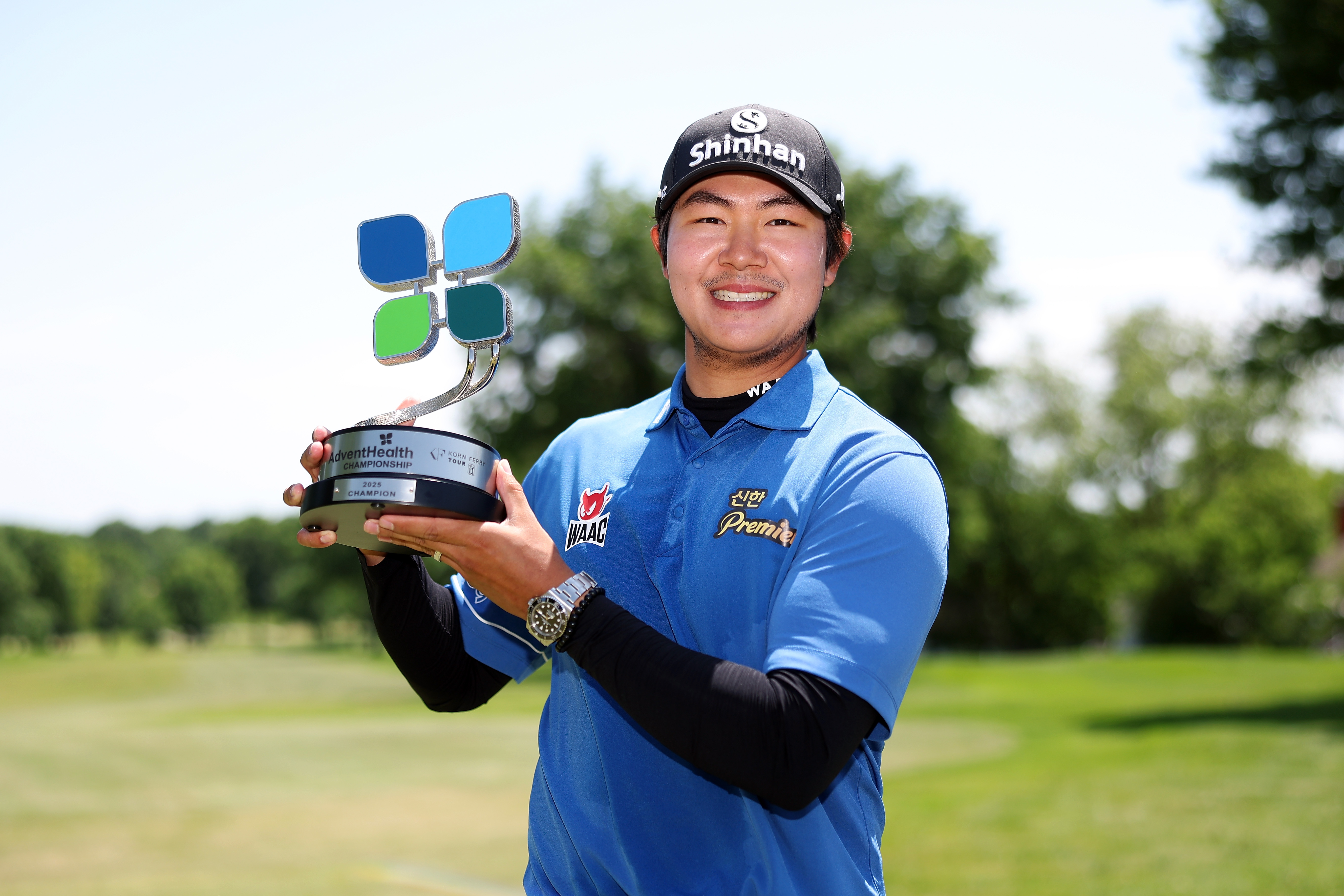 SH Kim holds a trophy
