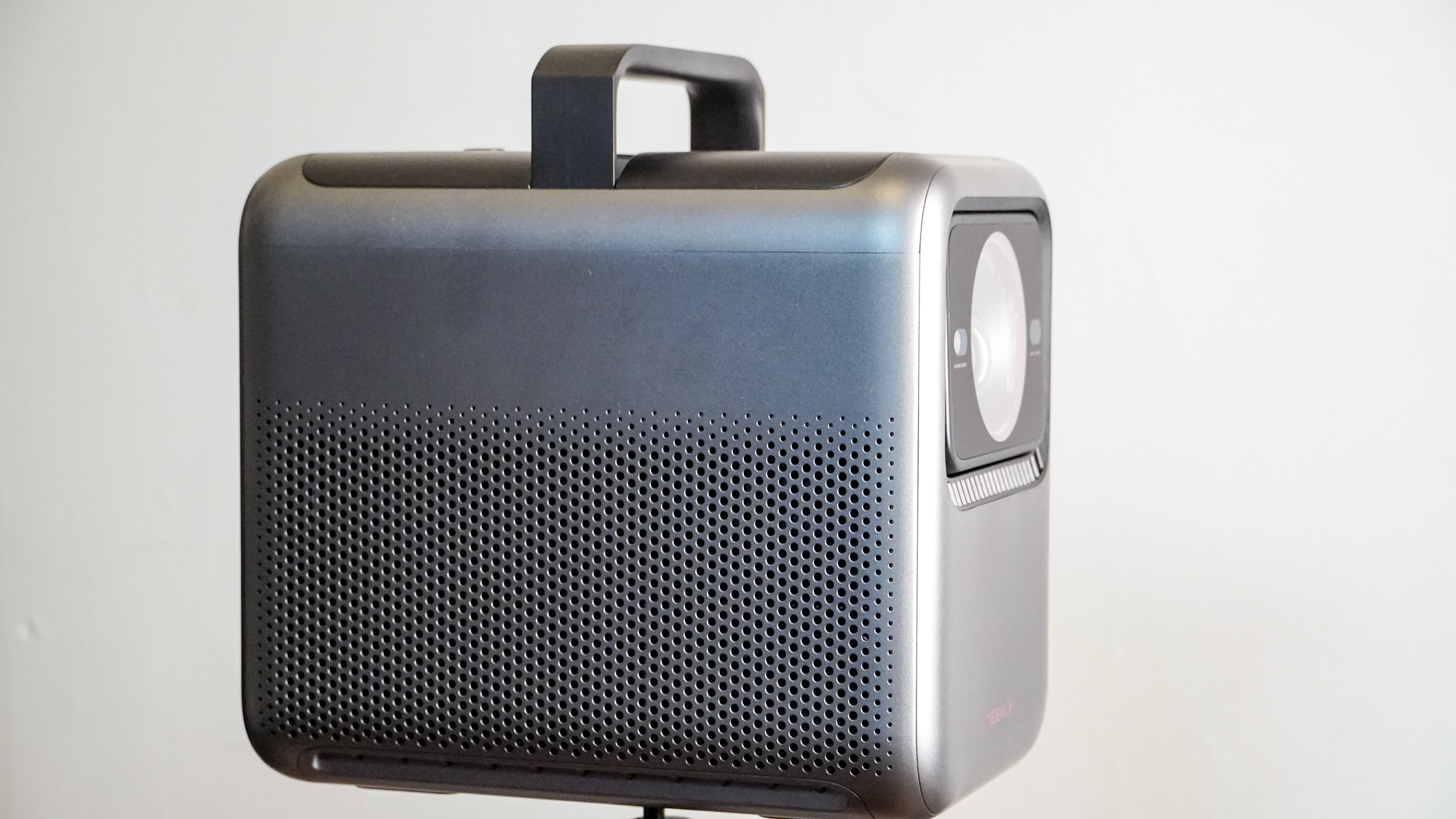 A side view of an Anker Nebula X1 projector with the handle up.