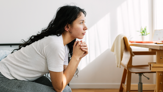 Woman looking out the window thoughtfully