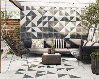 monochrome geometric wall and floor tiles on a modern patio with outdoor sofa