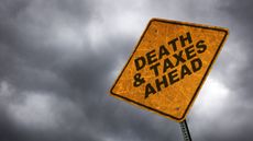 A caution sign against a stormy background reads "death and taxes ahead."