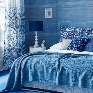 bedroom with blue walls and blue bed
