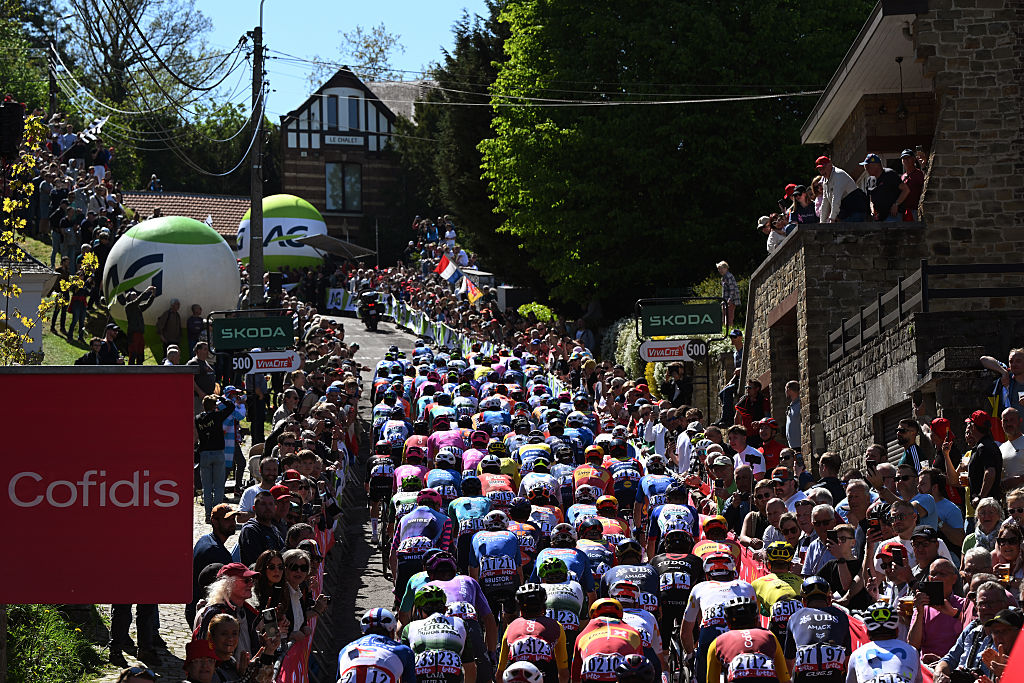 A general view of the peloton climbing to the Mur de Huy while fans cheer during the 90th La Fleche Wallonne