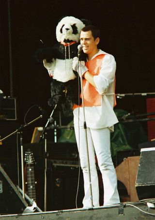 Peter Gabriel onstage at Knebworth with a cuddly panda bear toy