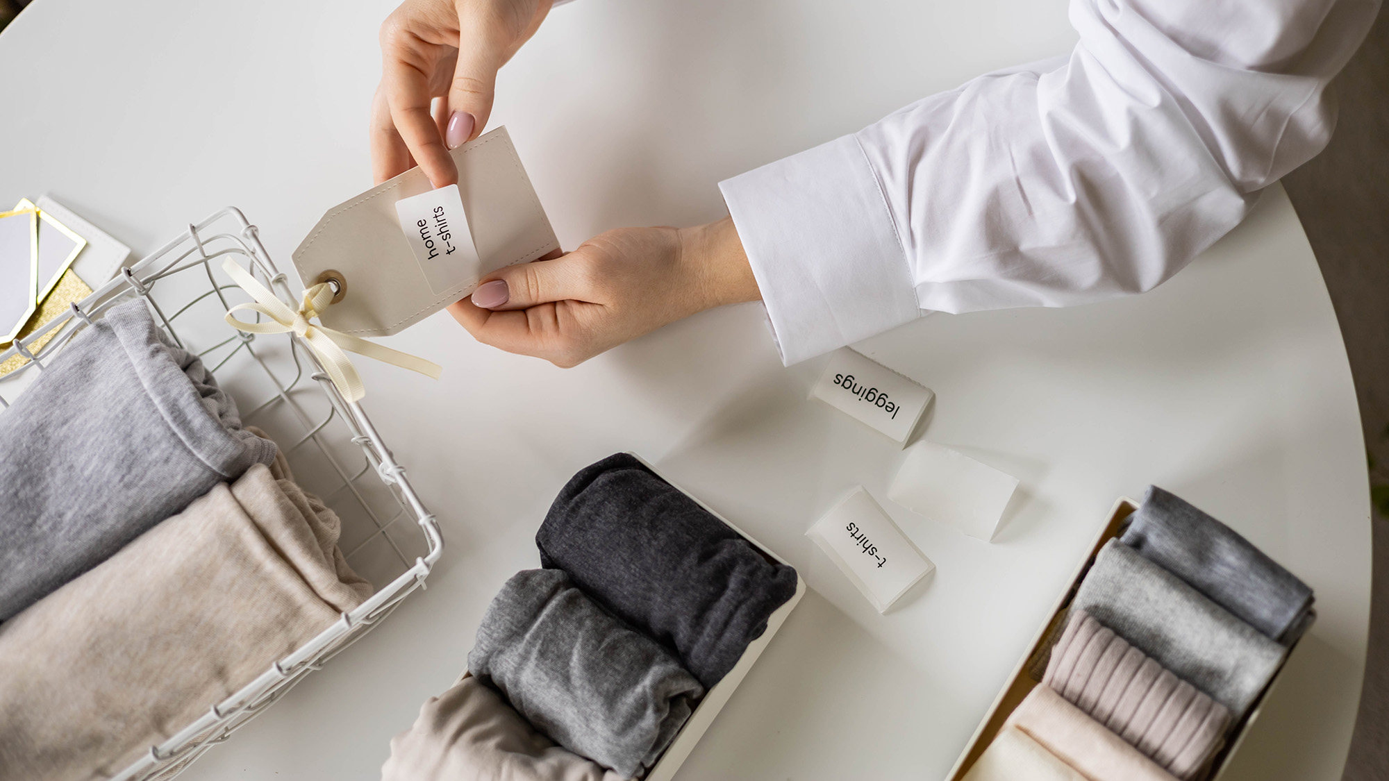 Woman adding labels to clothes storage