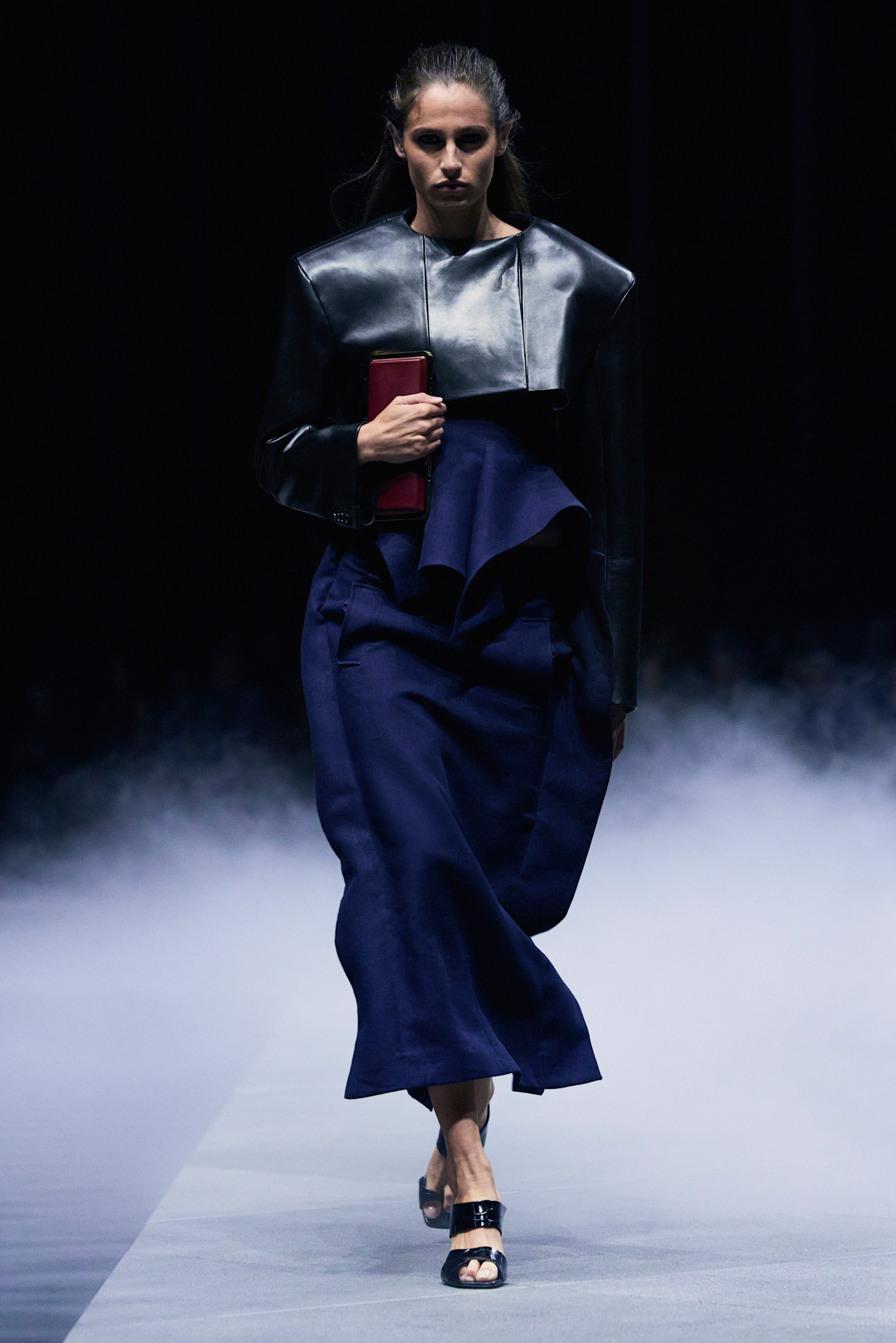 models at khaite holding clutches tight to their chest.