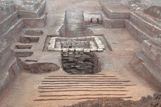 A panoramic view of the 2,300-year-old tomb (facing north), revealing two ramps that lead to a heavily robbed burial chamber.