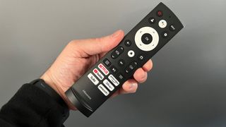Hisense U8H TV remote control held in hand
