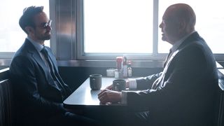 Matt Murdock and Wilson Fisk sitting opposite each other in a diner in Daredevil: Born Again