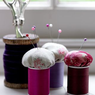 colourful pincushions with cotton reels