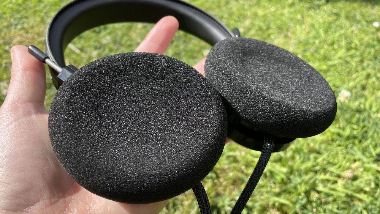 Becca holding the Grado SR80x headphones so you can see the foam interior.