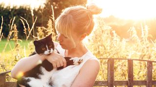 Owner cuddling her cat