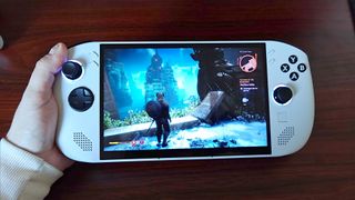 Hand holding Lenovo Legion Go S with Dragon Age: The Veilguard gameplay on screen