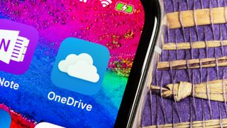 A close up photo of a smartphone screen with a shortcut for the OneDrive app displayed
