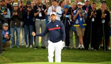 Tiger Woods fist pumps at the 2018 Ryder Cup in front of European fans
