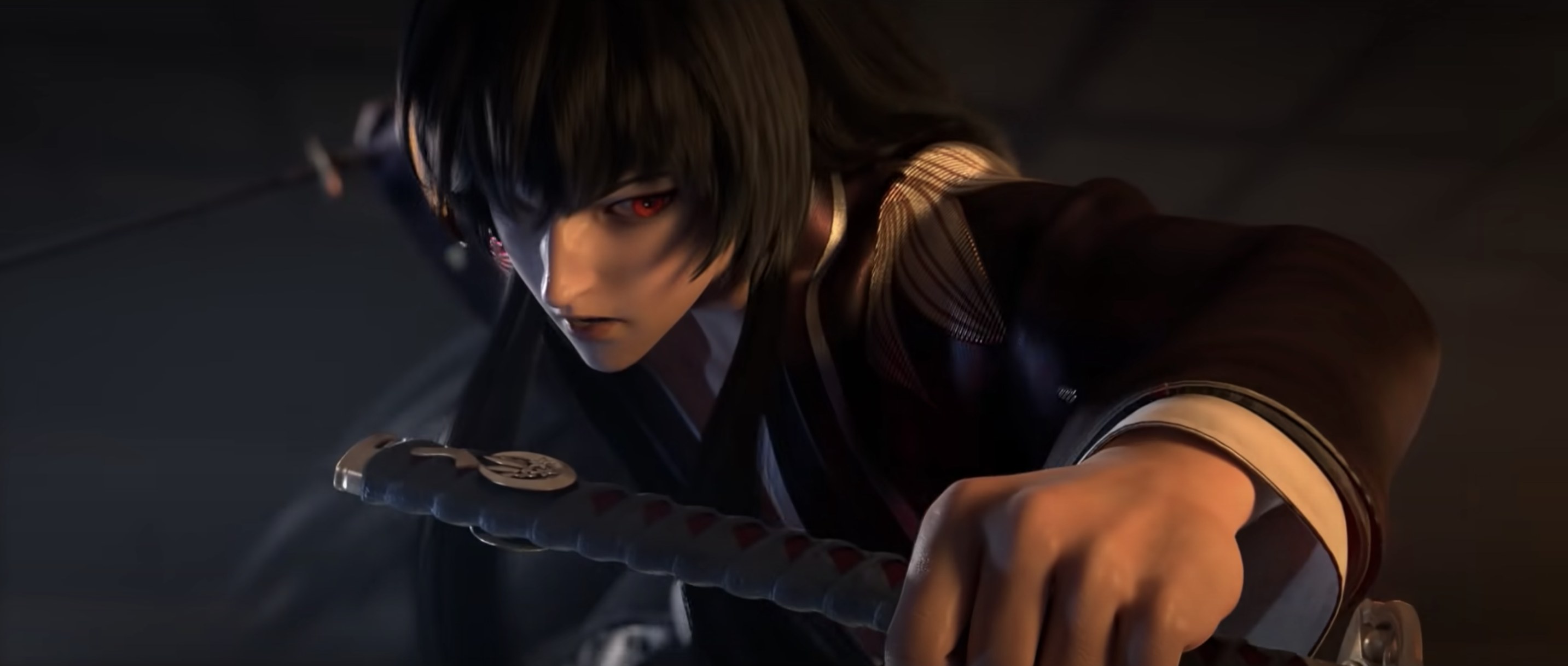 A close-up action shot of the character with long, black hair from the trailer. He’s holding two katanas, one in his left, and one in his right. He holds the one in his left behind him, ready to strike. His right hand is in the foreground, holding the katana defensively.