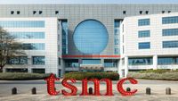 Red TSMC letters in front of a white TSMC building with a large round window