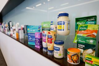 Unilever brand products including Hellman's mayonnaise and Knorr Alfredo sauce lined up on shelf