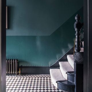Dark blue painted hallway with gloss finish on lower half of the wall
