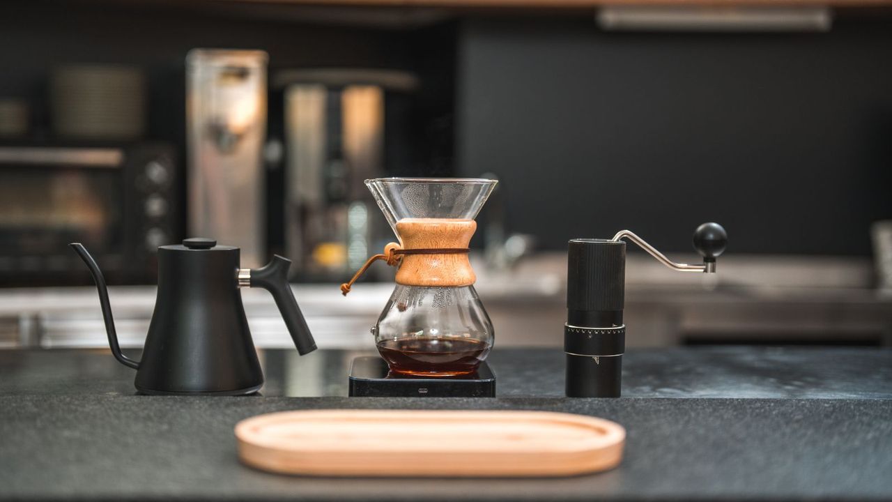 Three essentials for coffee bar organization ideas: a pour-over coffee maker, gooseneck kettle, and coffee grinder on the countertop