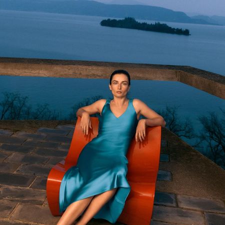 zara model sat down wearing blue satin spring dress