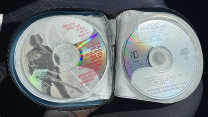A car's CD player and burned CDs, on a hot day
