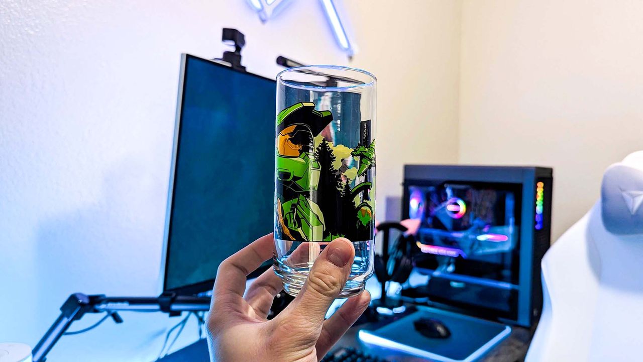An Xbox x IHOP collectible glass held in a hand, featuring unique art from Halo Infinite.