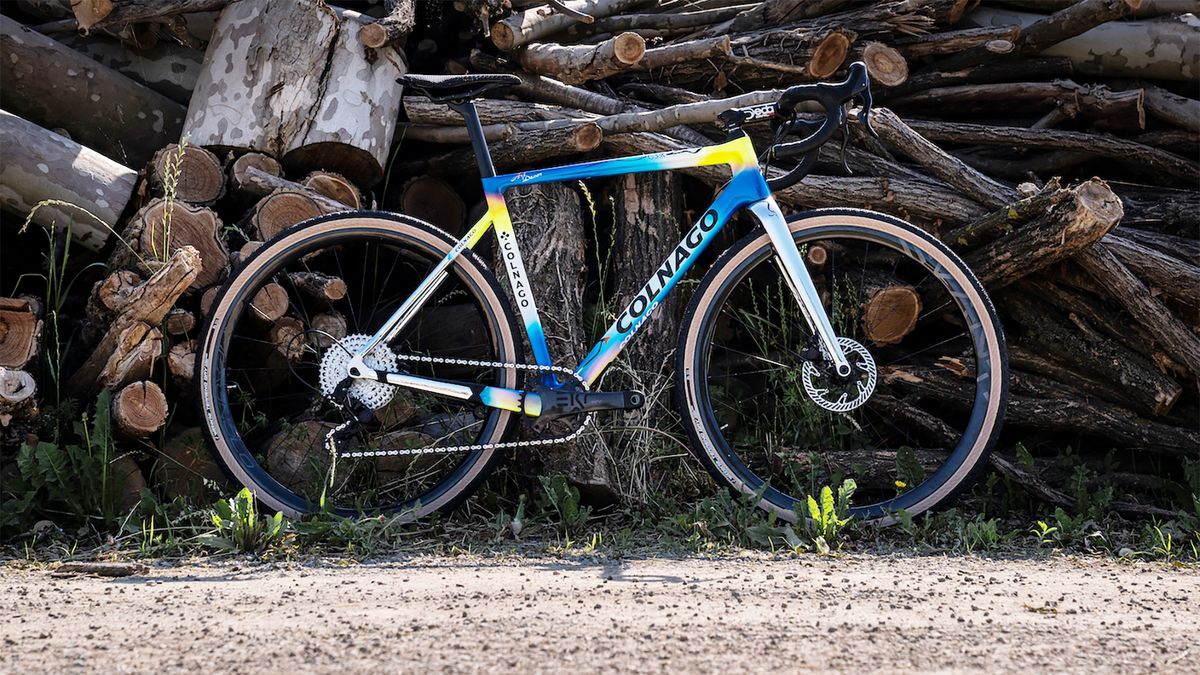 Custom painted Colnago G3x in front a wood pile