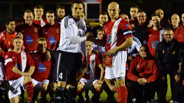 British Army football captain Keith Emmerson and the German Bundeswehr football captain Alexander Hess shake hands