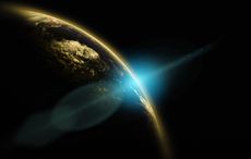 Planet Earth with sunrise and flare glint in background.