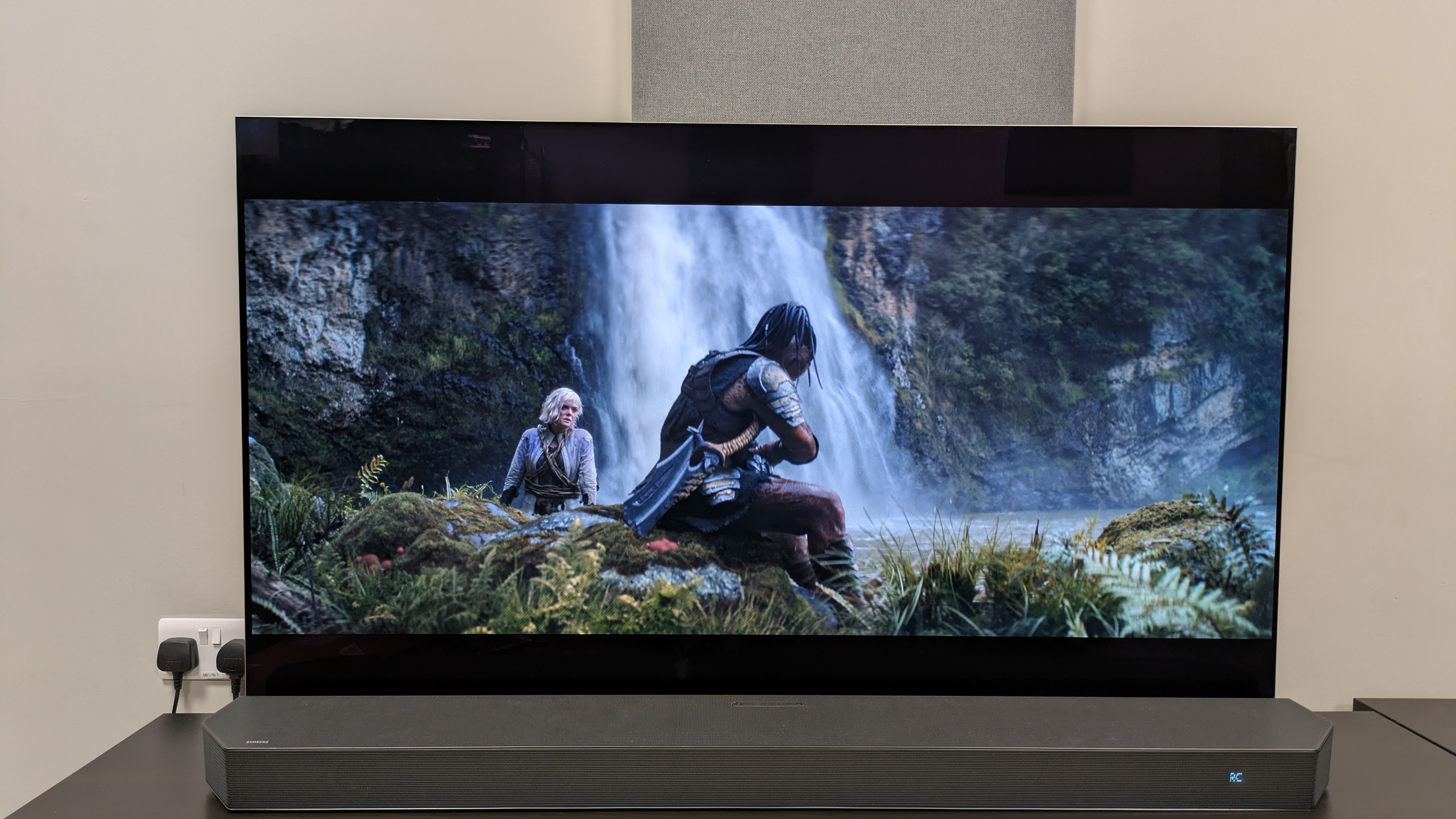 Predator: Badlands 4K Blu-ray on LG G5 showing Dek and Thia sat by waterfall 