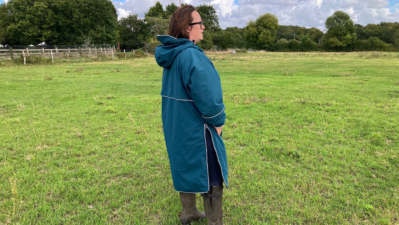 Lady wearing Two Bare Feet Hi-Vis Lightweight Riding Robe side view hood down