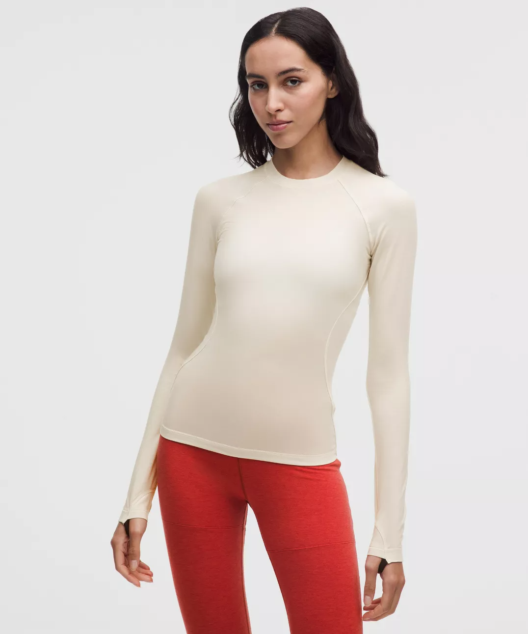 a model wearing a cream-coloured skiing base layer top from lululemon