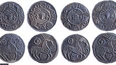 A close up of a series of round silver coins with various designs on them against a white background.