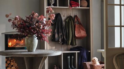 autumnal mudroom with foliage and hanging storage space