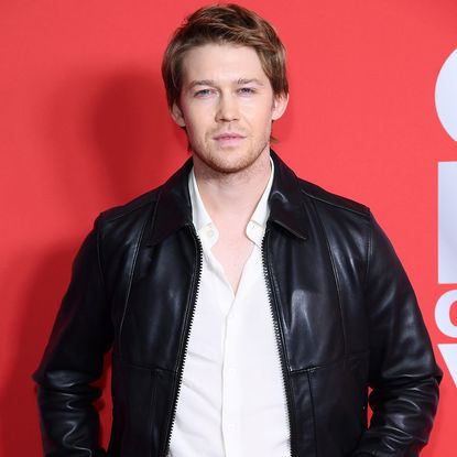 Joe Alwyn in a white shirt and black leather jacket and British comedian and presenter Amelia Dimoldenberg in a black gown at the GQ Men Of The Year Awards in London.