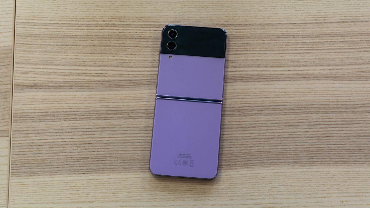 A photograph of the rear of the Samsung Galaxy Z Flip 4 unfolded on a table