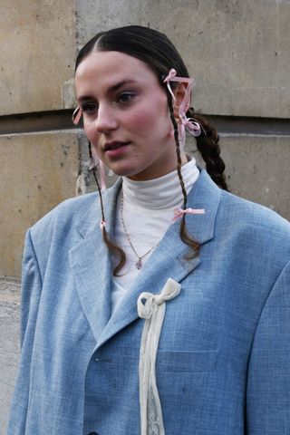 Callisto wearing the baby bows beauty trend at PFW AW24