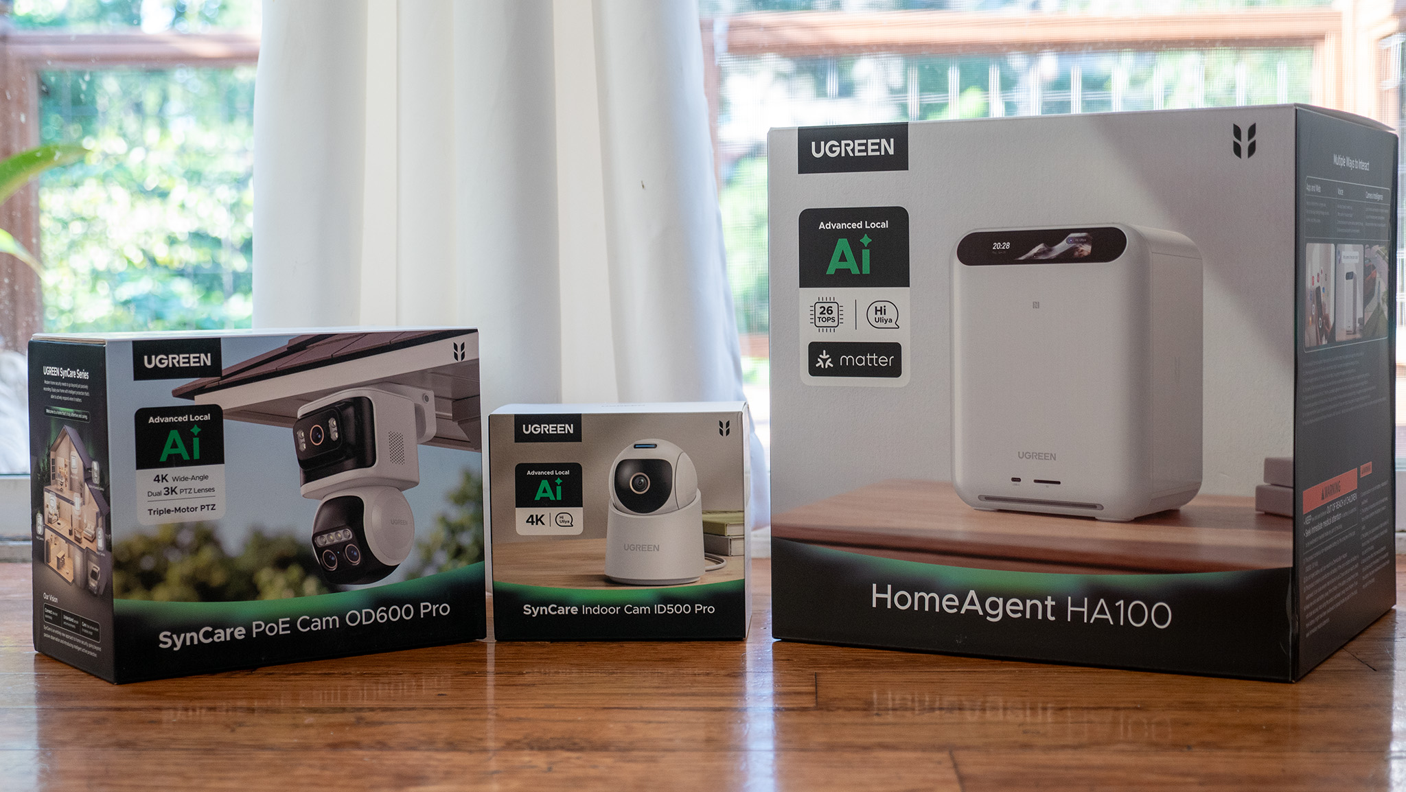 The boxes for the UGREEN HomeAgent HA100, SynCare PoE Cam OD600 Pro, and SynCare Indoor Cam ID500 Pro