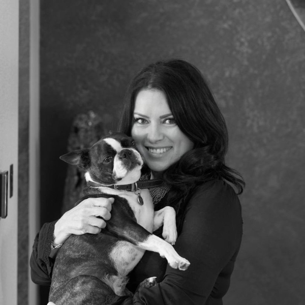 a press shot of manuela hamilford of hamilford design in black and white holding her dog