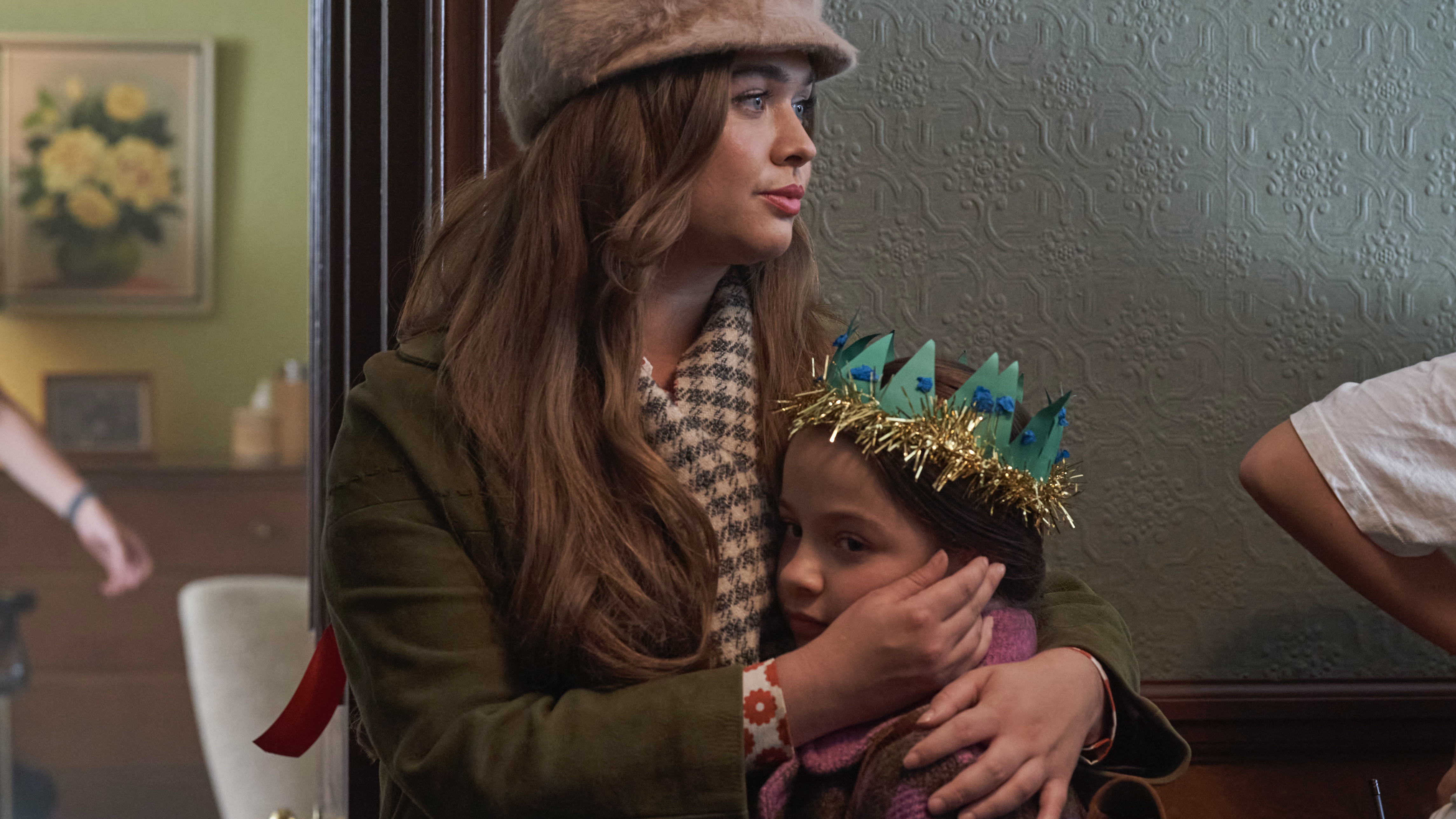 Megan Cusack in a fur hat as Nancy cradles Francesca Fullilove in a Christmas hat as Colette in Call the Midwife.