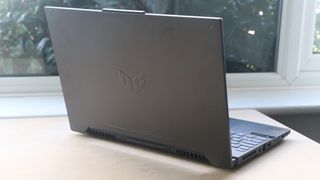 Asus Tuf Gaming F15 laptop on a wooden surface