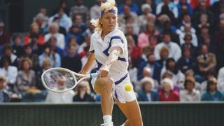Martina Navratilova of the United States stretches to make a back hand return during the Women's Singles Final match against Zina Garrison at the Wimbledon Lawn Tennis Championship on 7th July 1990 at the All England Lawn Tennis and Croquet Club in Wimbledon in London, England. Martina Navratilova won the match and championship 6–4, 6–1.
