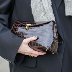 Marissa Cox wears a brown leather bag with crocodile patterns, during a street style fashion photo session, on December 04, 2024 in Paris, France